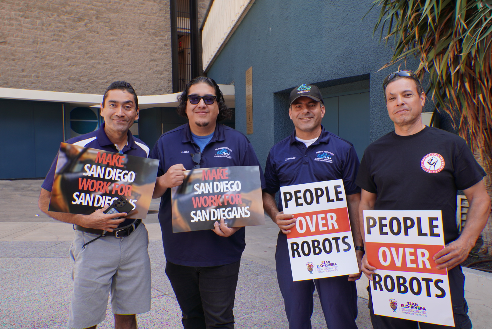 Luis Arias, Librado Rivera and driver representatives standing together